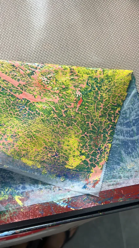 pulling a collage paper print from a 