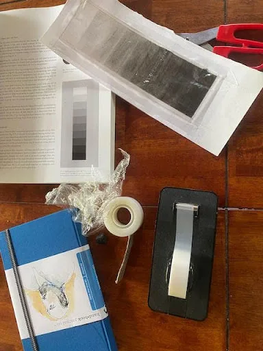 making-value-chart-with-charcoal-and-laminating-with-reused-shrink-wrap-and-found-garbage-art-supplies